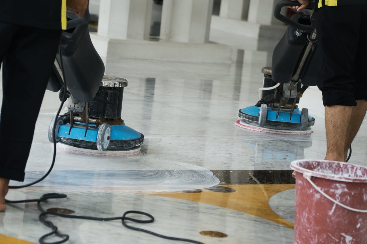 Master technicians buffing a marble floor